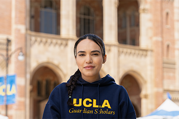 Johanna Carbajal in front of Royce Hall wearing Guardian Scholars hoodie