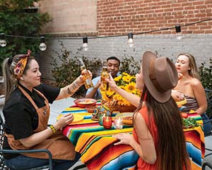 Multiracial group of young people eating at a table