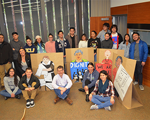 Tobias Higbie with students holding labor and organizing signs