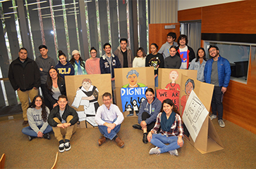 Tobias Higbie with students holding labor and organizing signs