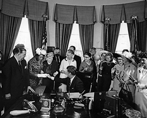 equal_pay_363 Black-and-white photo of President John F. Kennedy signing the Equal Pay Act