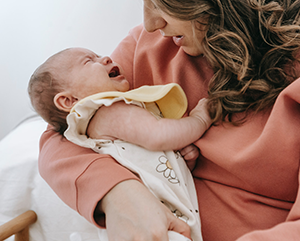 Mother holding crying baby