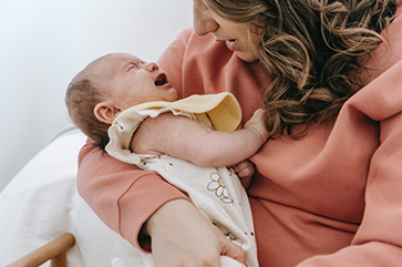 Mother holding crying baby