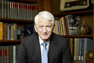 Chancellor Block in an office with bookcases in the background.