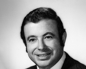 Harding_363 Black and white head and shoulders photo of Wayne Harding smiling.