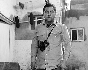 Jason De León standing with camera