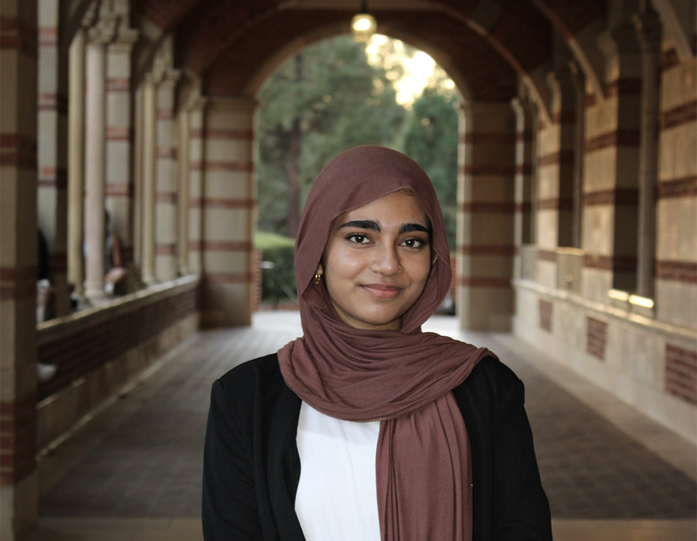 Tasnim Jahan standing in the stone corridor of Royce Hall 