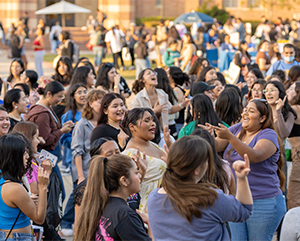 A crowd of students dancing and singing in Wilson Plaza during Latinx Welcome 2023