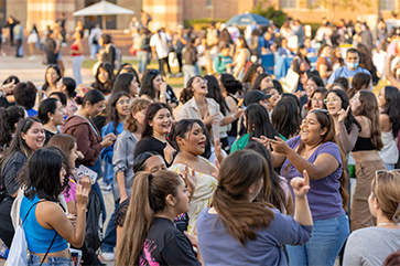 A crowd of students dancing and singing in Wilson Plaza during Latinx Welcome 2023