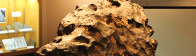 A 357-pound iron chunk of an asteroid that crashed into Arizona nearly 50,000 years ago, creating a mile-wide crater on display at the UCLA Meteorite Gallery.