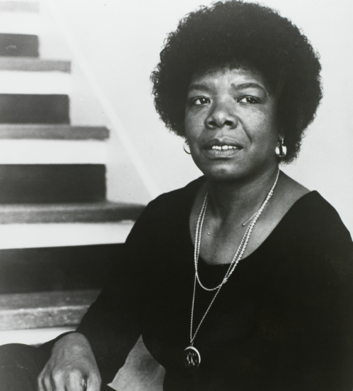 A black and white photograph of Maya Angelou with a staircase in the background.