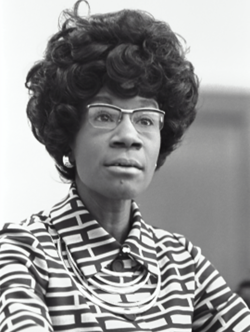 A black and white, head and shoulders photograph of Shirley Chisholm.
