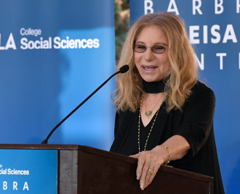 Barbra Streisand standing at a podium.