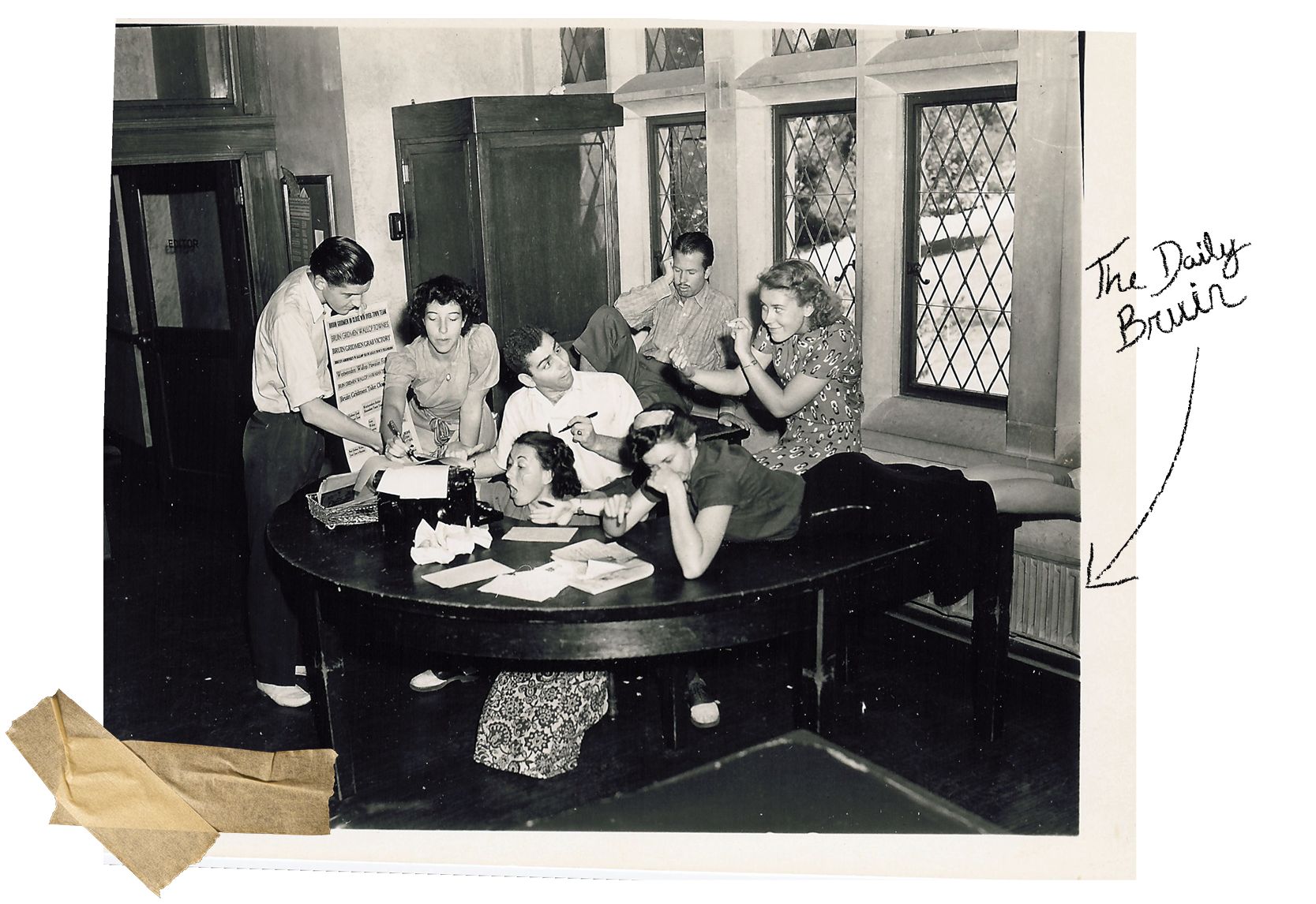 A black and white photograph of student staff members of the Daily Bruin in the 1950s posing for a humorous group shot.