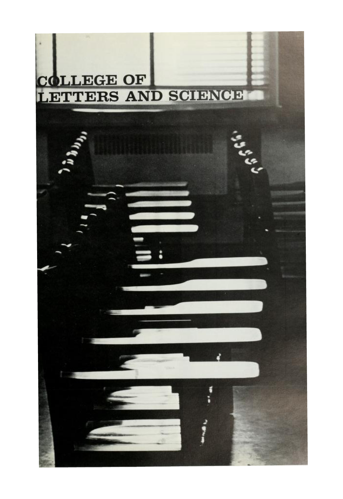 A black and white photograph of a row of empty desks with the words, "College of Letters and Science," superimposed in black in the upper left-hand side.