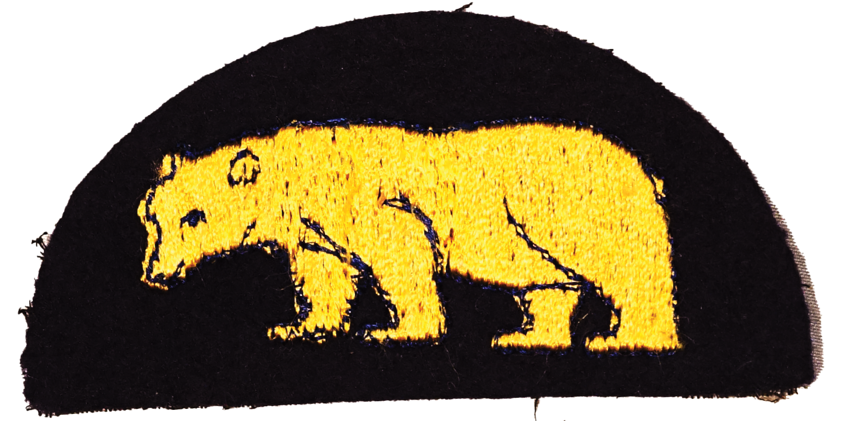 A black patch with a golden bear embroidered.