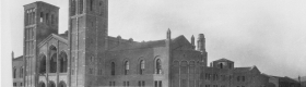 A black and white photograph of cars from the 1920s and building materials surrounding Royce Hall.