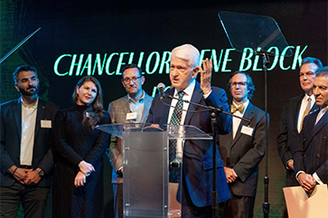 Chancellor Block speaking at podium after receiving award from LABC, with others in the background