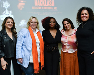 From left to right: Guylaine Maroist, Sarah T. Roberts, Kiah Morris, Kristy Guevara-Flanagan, Safiya Noble stand in front of screen featuring “Backlash: Misogyny in the Digital Age”