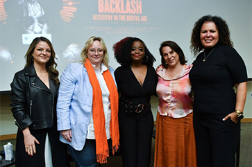 From left to right: Guylaine Maroist, Sarah T. Roberts, Kiah Morris, Kristy Guevara-Flanagan, Safiya Noble stand in front of screen featuring “Backlash: Misogyny in the Digital Age”