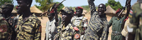 Soldiers in Sudan, some holding rifles up in the air