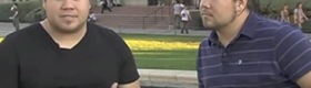 Caleb Dunlap in black shirt (left) and his brother, Jared Dunlap, in dark striped shirt with Powell Library in background