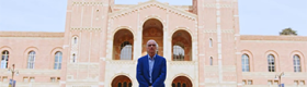 Robert Gurval standing with arms crossed in front of Royce Hall