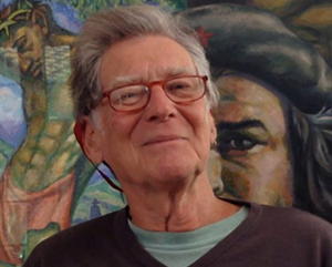 David Kunzle in front of a mural.