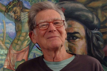 David Kunzle in front of a mural.