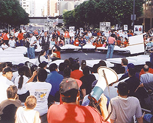 A group of union protesters with signs in the middle of a Los Angeles street