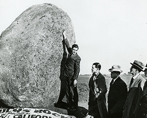 A black and white photograph of photo of five men standing at Founders’ Rock.