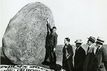 A black and white photograph of photo of five men standing at Founders’ Rock.