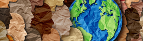 Photo of a paper collage of various faces in profile and the Earth