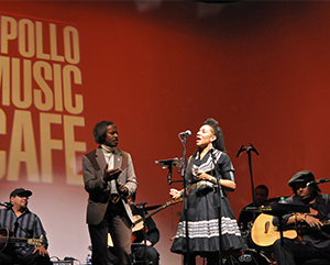 Martha Redbone singing on stage in a black dress