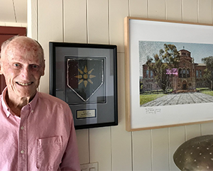 A photograph of Norman J. Powell in a salmon colored shirt.