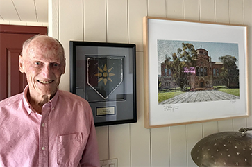 A photograph of Norman J. Powell in a salmon colored shirt.