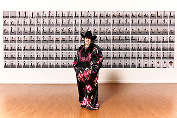 Erika Hirugami standing in front of exhibit