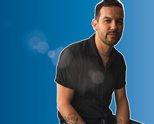 Justin-Torres-portrait-with-blue-background-363-241 A composite image of Justin Torres against a blue background.