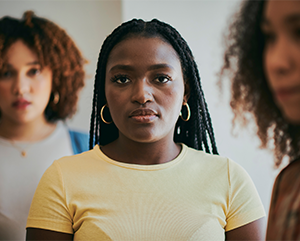 three young women looking wearing a look of concern on their faces.