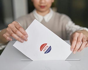 Woman places vote in ballot box