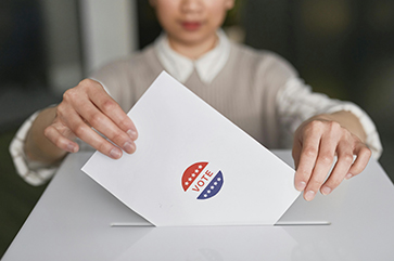 Woman places vote in ballot box