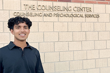 Anish posing in front of UCLA's Counseling and Psychological Services office