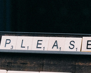 PLEASE-363-241 Scrabble-like tiles spell out the word “please.”