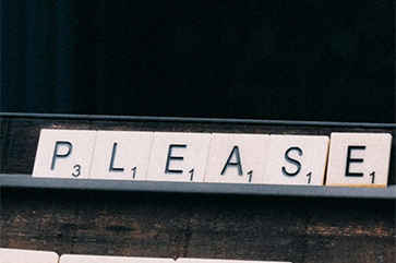 Scrabble-like tiles spell out the word “please.”