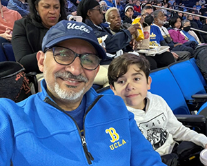 Shahawi-363-241 Alumnus Ihab Shahawi with his grandson at a UCLA basketball game.