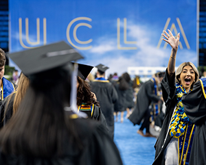 Hero+commencement-2024-363-241 Students celebrate commencement with UCLA sign in background