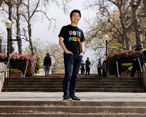 Shi_363-241 Shi wearing wearing a shirt that says, "VOTE NOW," on Bruin Walk.