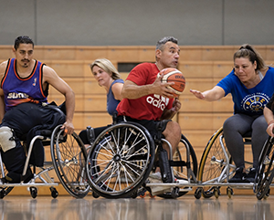 Adaptive-Programs_Basketball-363-241 An action shot of five players who participate in UCLA Open Rec wheelchair basketball, with Alvin Malave holding the ball.