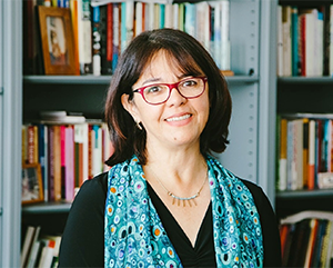 Cecilia+Menjivar+363-241 UCLA sociology professor Cecilia Menjívar stands in front of a full bookcase.