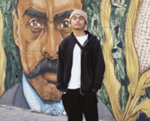 Frank-Godinez-363-241 Frank Godinez standing in front of a mural